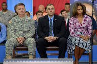 U.S. Army Maj. Gen. James McConville the commanding general of the 101st Airborne Division (Air Assault) &quot;Screaming Eagles;&quot; Sgt. Aaron Wanless from the 4th Brigade Combat Team; and first lady Michelle Obama sit on stage as the second lady, Jill Biden, speaks to soldiers, family members and employers during the Veterans Job Summit and Career Forum at Fort Campbell, Ky.