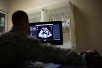 U.S. Air Force medical technician performs an ultrasound on a patient.