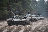Ukrainian soldiers on captured Russian T-72 tanks.