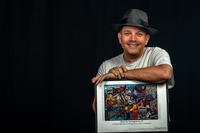 Senior Master Sgt. Bob Barko Jr. poses with one section of his giant mural of Youngstown, Ohio, pop culture at Youngstown Air Reserve Station.