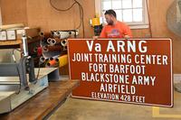 Employees make &quot;Fort Barfoot&quot; signs to replace existing &quot;Fort Pickett&quot; signs.