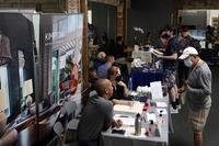 Prospective employers and job seekers interact during a job fair in Los Angeles.