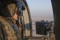A UH-60 Blackhawk crew chief flies over the Syrian countryside.