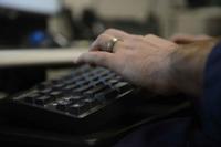 A U.S. Coast Guard information systems technician works at his desk.