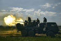 Ukrainian soldiers fire a cannon near Bakhmut, Ukraine.