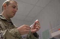 Airman prepares a Covid-19 vaccine at Ramstein Air Base Germany,