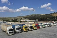 Trucks loaded with humanitarian aid sit parked at Turkey's border. 
