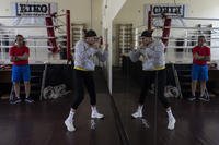 Ukrainian boxer Anna Lysenko shadow boxes while training with her coach Oleksandr Salenko
