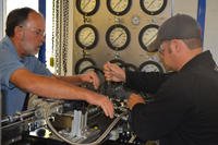 Parker Hannifin Corp. field service technician Craig Hanes and Collin Brumbelow, 550th Commodities Maintenance Squadron Hydraulics technician, take an actuator off a test stand in the C-17 Globemaster III hydraulic actuator overhaul work area in Midwest City, Oklahoma.