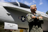 Rear Adm. Douglas Verissimo, commander of Naval Air Force Atlantic, poses in front of an F/A-18 Hornet.