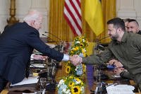 President Joe Biden shakes hands with Ukrainian President Volodymyr Zelenskyy