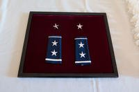 Stars and shoulder marks are prepared for a promotion ceremony