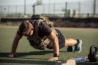 A member of Special Operations Joint Task Force-Operation Inherent Resolve wears a ballistic vest while doing a push-up at Camp Arifjan, Kuwait.