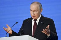 Russian President Vladimir Putin gestures while speaking