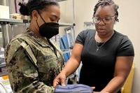 Jaquetta Hudson, a medical assistant at Naval Branch Health Clinic King Bay’s Family Medicine Clinic, helps Hospitalman Ariana Bessee identify the proper wrist splint for a patient. (U.S. Navy photo by Deidre Smith, Naval Hospital Jacksonville) Medical assistant fits a wrist splint for a patient