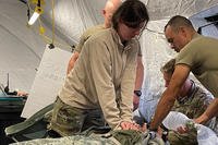 920th Aeromedical Staging Squadron and 315th Aeromedical Evacuation Squadron airmen conduct cardiac arrest training during exercise Distant Horizon at Bradshaw Army Airfield, Hawaii.