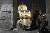 Palestinian Muslims break their fast during Ramadan outside the Dome of Rock.