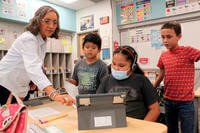 Teacher Arleen Franklin explains a math lesson to her students at Judy Nelson Elementary School in Kirtland, N.M.