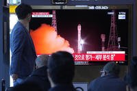 news program broadcasting file images of a rocket launch by North Korea, at the Seoul Railway Station