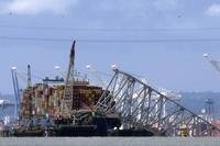 The collapsed Francis Scott Key Bridge rests on the container ship Dali