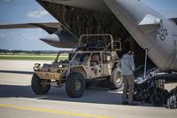 Airmen unload a search and rescue tactical vehicle