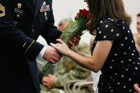 A spouse receives flowers during her husband's retirement ceremony