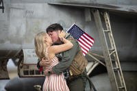 military spouse kisses her husband after he returned to NAS Oceana in Virginia Beach, Virginia