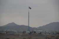 A North Korean flag flutters in the wind.