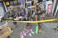 South Korean army soldiers collect the trash from a balloon presumably sent by North Korea