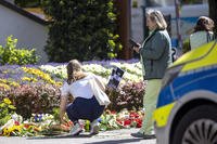 Flowers and candles are placed in Solingen, Germany.