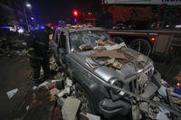 damaged car near a building that was hit in an Israeli airstrike, in Beirut, Lebanon