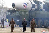 North Korean leader Kim Jong Un walks near what it says is a Hwasong-17 intercontinental ballistic missile