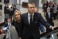 Pete Hegseth, President-elect Donald Trump's nominee to be defense secretary, is joined by his wife, Jennifer Rauchet, as they walk through the basement of the Capitol.