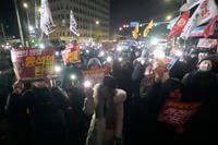 People gather to demand South Korean President Yoon Suk Yeol to step down in front of the National Assembly in Seoul, South Korea