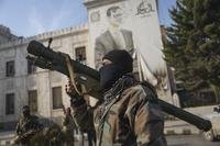 A Syrian opposition fighter holds a rocket launcher.