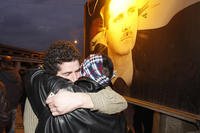 A freed Syrian prisoner, left, hugs his brother after being released from Adra Prison on the northeast outskirts of Damascus