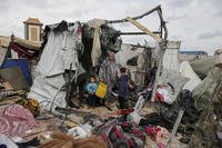 Displaced Palestinians inspect their tents destroyed by Israel's bombardment, adjunct to an UNRWA facility west of Rafah city, Gaza Strip