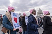 Anti-abortion activists walk past the Capitol