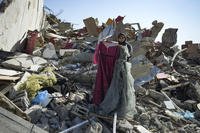 Nour Abu Al Zamar salvages items from her home in Rafah