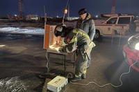 firefighters and rescuers work at the industrial site damaged after Ukrainian drones' attack in Saratov, Russia