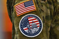 An Army National Guard soldier's arm shows uniform patches