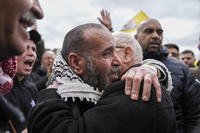 Palestinian prisoners are greeted as they exit a Red Cross bus