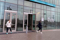Two pedestrians walk on the campus of Tufts University