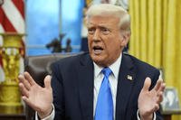 President Donald Trump speaks with reporters in the Oval Office at the White House