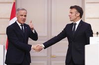 Canada Prime Minister Mark Carney, left, gives a thumbs up as he shakes hands with President of France Emmanuel Macron