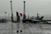 Rafale jet fighter next to a French flag