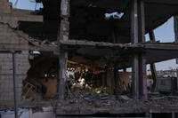 Palestinians have dinner inside their .destroyed apartment decorated for the holy month of Ramadan