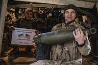Soldiers of Ukraine's 5th brigade hold a poster thanking the US for support