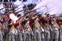 British Regulars fire on New England colonial militia during a reenactment celebration.