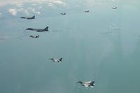 two U.S. Air Force B-1B bomber, top left, fly over the Korean Peninsula